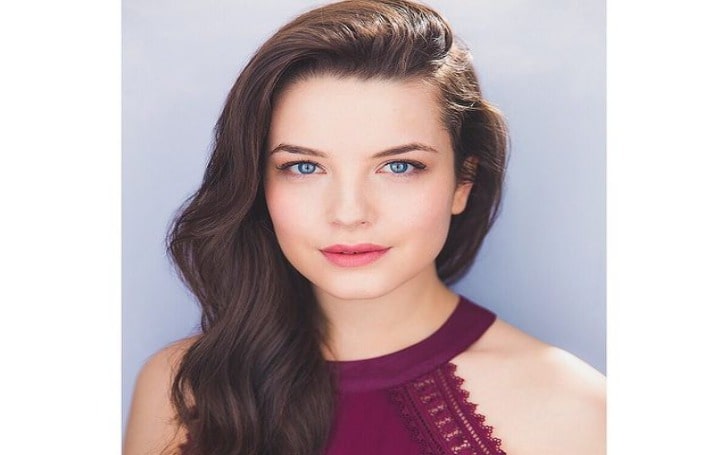 Lauren Norvelle in a maroon sleeveless top.